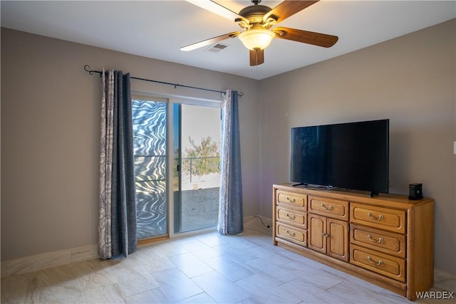 interior space with baseboards, access to outside, visible vents, and a ceiling fan