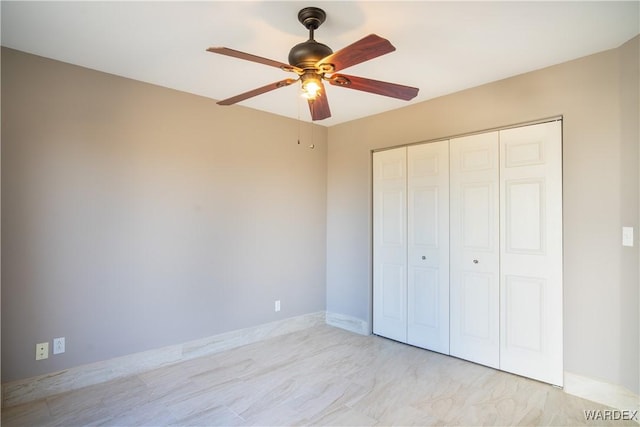 unfurnished bedroom with a closet and ceiling fan