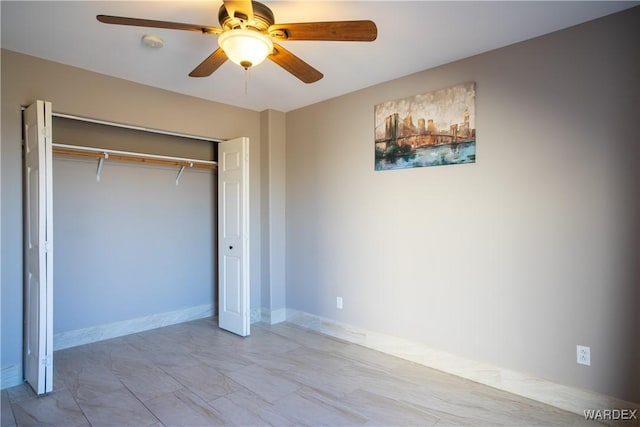 unfurnished bedroom featuring a closet, a ceiling fan, and baseboards