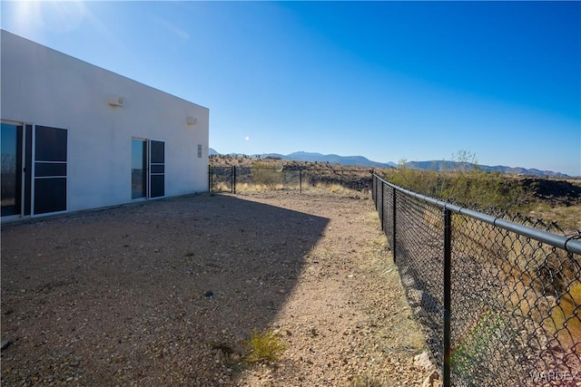 view of yard with fence and a mountain view