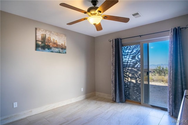 unfurnished room featuring baseboards, visible vents, and ceiling fan