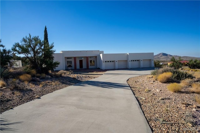 pueblo-style house featuring a mountain view and stucco siding