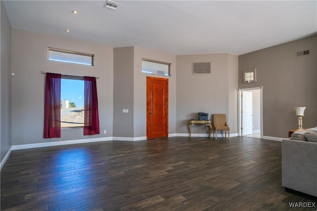 living room with visible vents and dark wood-style flooring