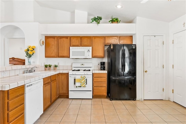 2191 Sierra Santiago, Bullhead City, AZ 86442 - kitchen with white appliances, a sink, lofted ceiling, tile counters, and a peninsula