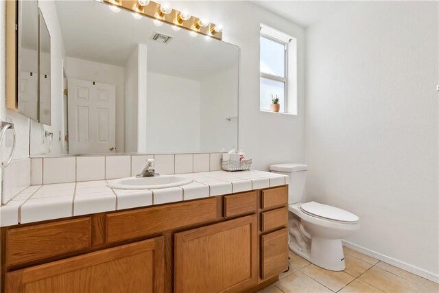 2191 Sierra Santiago, Bullhead City, AZ 86442 - bathroom featuring vanity, tile patterned floors, toilet, and baseboards