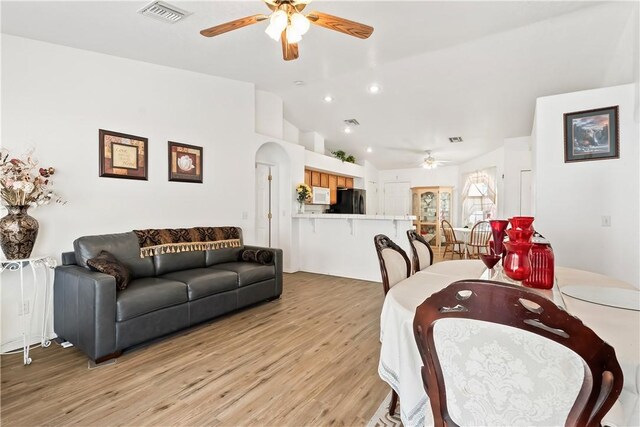2191 Sierra Santiago, Bullhead City, AZ 86442 - dining area with ceiling fan, lofted ceiling, light wood-style flooring, arched walkways, and recessed lighting