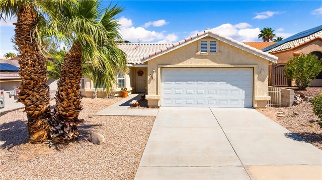 2191 Sierra Santiago, Bullhead City, AZ 86442 - view of front of property featuring stucco siding, a garage, concrete driveway, and a tiled roof