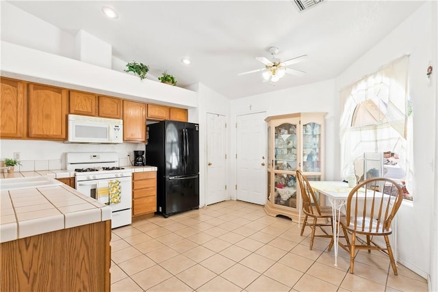 2191 Sierra Santiago, Bullhead City, AZ 86442 - kitchen featuring white appliances, tile countertops, light tile patterned flooring, ceiling fan, and recessed lighting