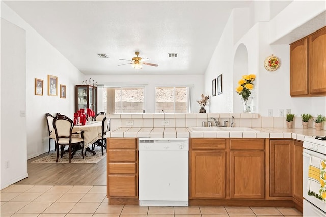 2191 Sierra Santiago, Bullhead City, AZ 86442 - kitchen with white appliances, tile countertops, ceiling fan, a sink, and brown cabinets