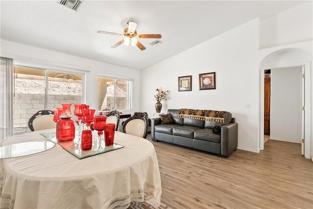 2191 Sierra Santiago, Bullhead City, AZ 86442 - dining room with a ceiling fan, light wood-style floors, arched walkways, and high vaulted ceiling