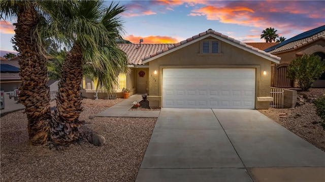 2191 Sierra Santiago, Bullhead City, AZ 86442 - mediterranean / spanish house with stucco siding, a garage, concrete driveway, and a tiled roof