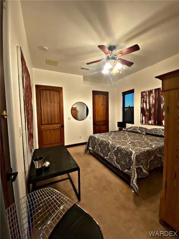 carpeted bedroom featuring ceiling fan and baseboards