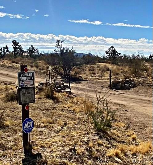 view of street featuring a rural view and traffic signs