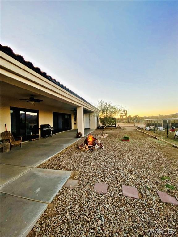 view of yard with a rural view, a mountain view, an outbuilding, and an exterior structure