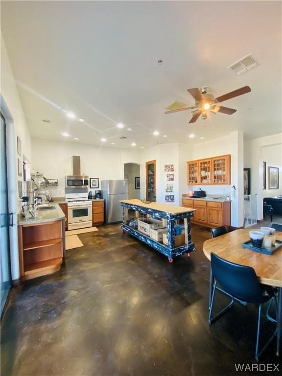 interior space featuring concrete floors, a sink, visible vents, light countertops, and appliances with stainless steel finishes