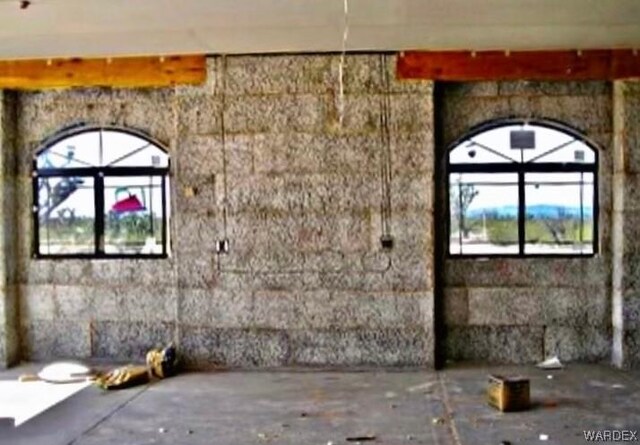 view of front of house featuring a garage, a tile roof, central AC unit, and stucco siding