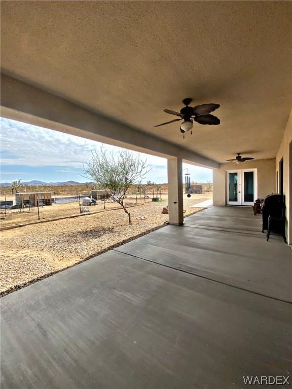 view of patio / terrace with a mountain view and a ceiling fan