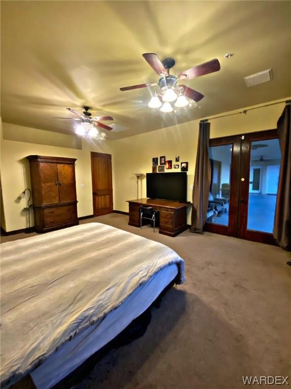 bedroom with a ceiling fan, access to outside, visible vents, and light carpet