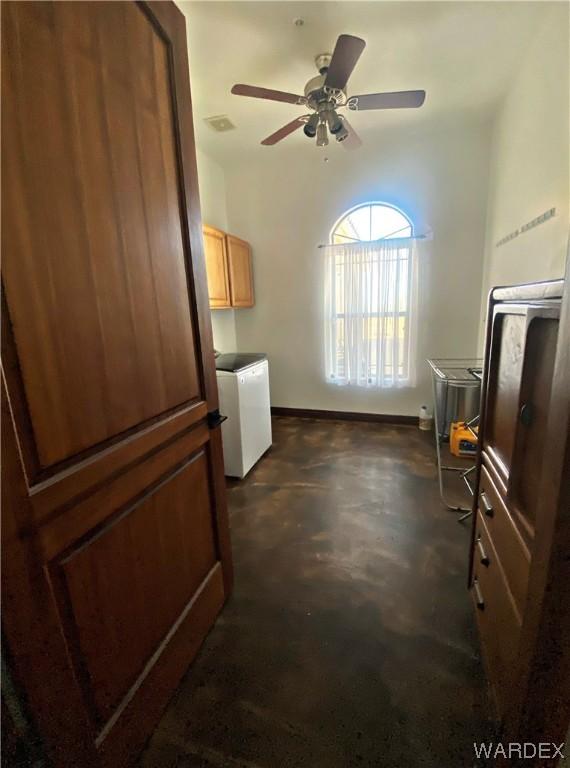 kitchen featuring a sink, visible vents, baseboards, light countertops, and washer / dryer