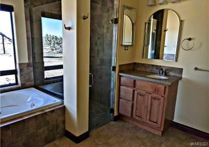 bathroom with a garden tub, a shower stall, and vanity