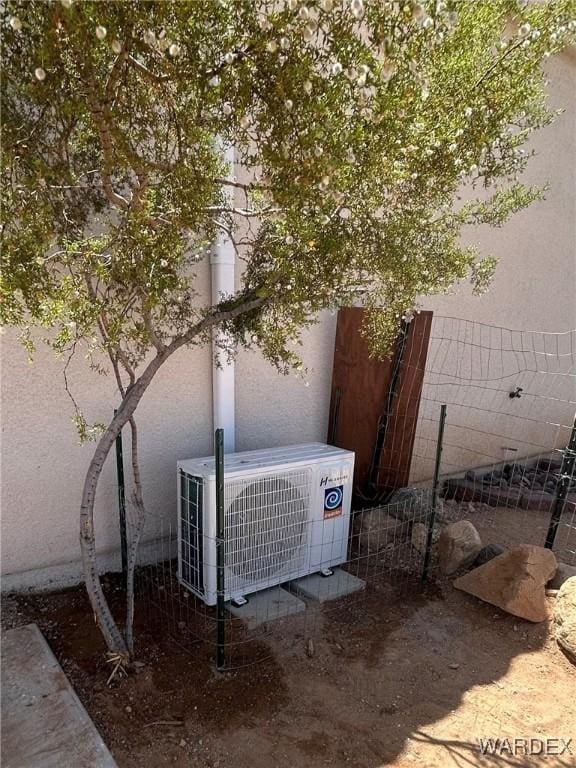 details featuring ac unit and fence