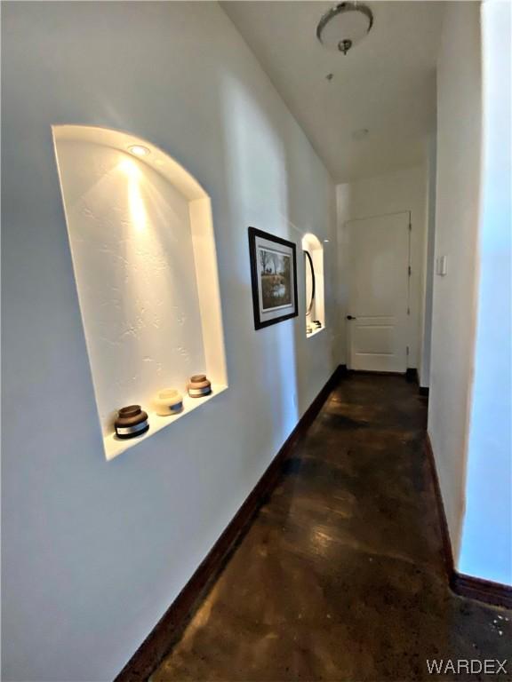 interior space with concrete flooring and a ceiling fan