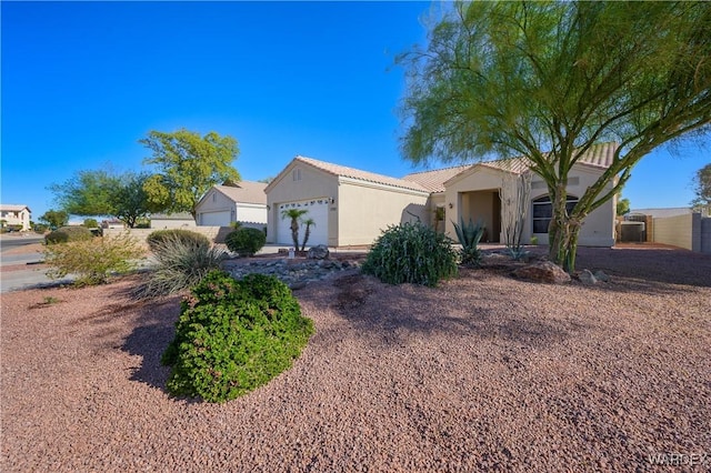 single story home featuring an attached garage and stucco siding