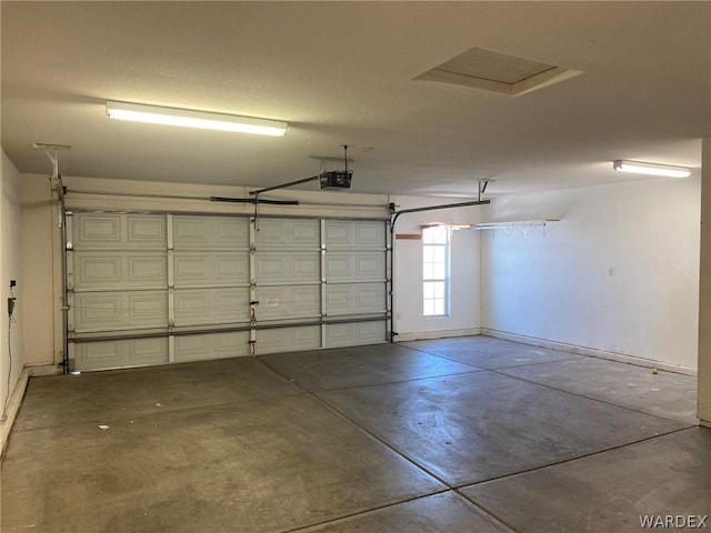 garage with baseboards and a garage door opener