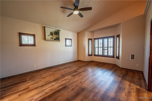 unfurnished room featuring ceiling fan, vaulted ceiling, baseboards, and wood finished floors