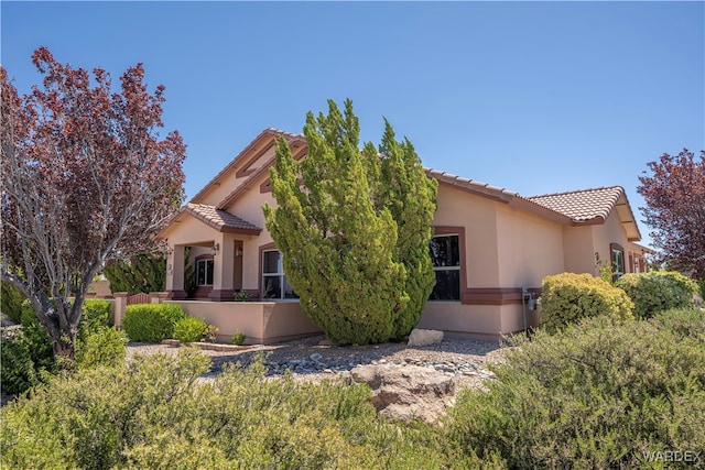 view of front of home featuring a tile roof and stucco siding