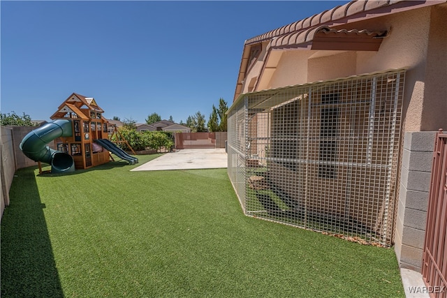 view of yard with a fenced backyard, a playground, and a patio