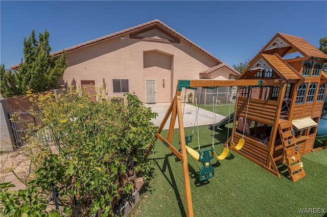 view of playground with fence and a yard