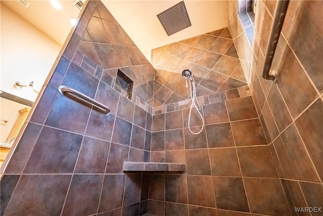 interior details with tiled shower and visible vents