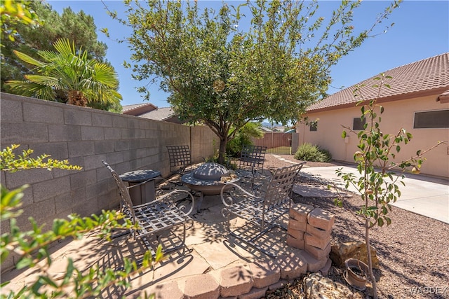 view of patio / terrace featuring a fire pit and a fenced backyard