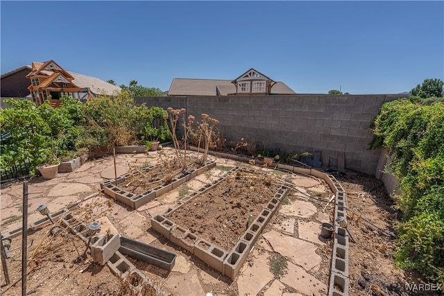 view of yard featuring a garden and a fenced backyard