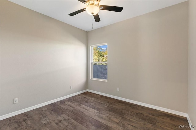 unfurnished room with dark wood-style floors, baseboards, and a ceiling fan