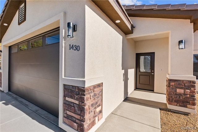 property entrance featuring stone siding and stucco siding