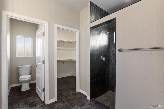 full bathroom featuring a walk in shower, tile patterned flooring, toilet, and baseboards