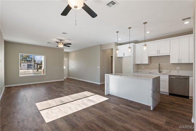 kitchen with visible vents, hanging light fixtures, stainless steel dishwasher, white cabinetry, and a kitchen island