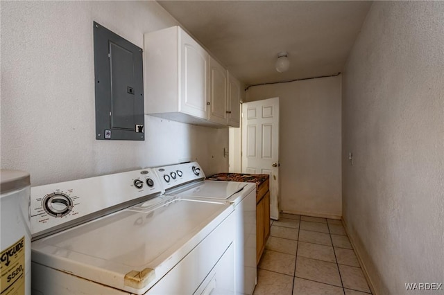 laundry area with light tile patterned floors, cabinet space, a textured wall, separate washer and dryer, and electric panel