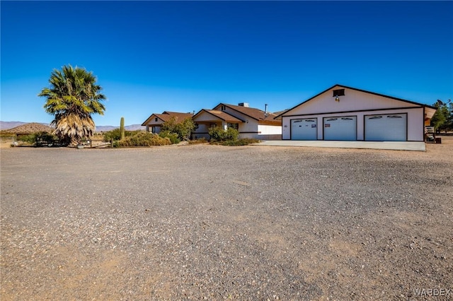 view of front facade with a garage and a mountain view