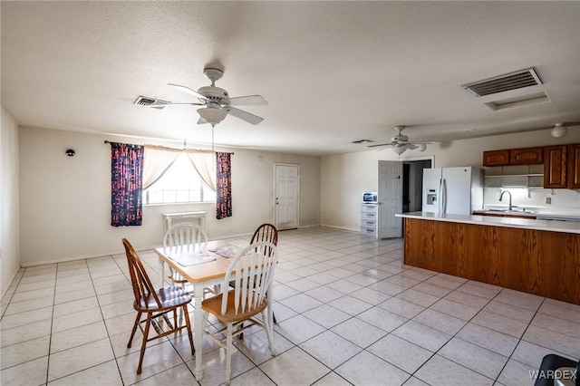 dining space with light tile patterned floors, ceiling fan, and visible vents