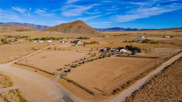 drone / aerial view featuring a rural view, a mountain view, and view of desert