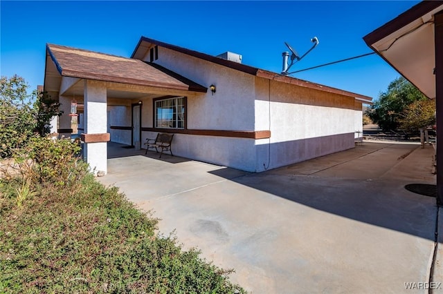 exterior space featuring central air condition unit, a patio, and stucco siding