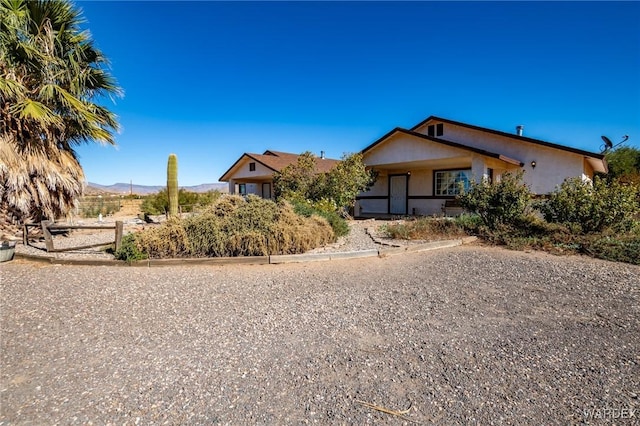 view of front facade with a mountain view and stucco siding