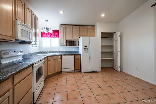 kitchen featuring white appliances, recessed lighting, pendant lighting, and an inviting chandelier