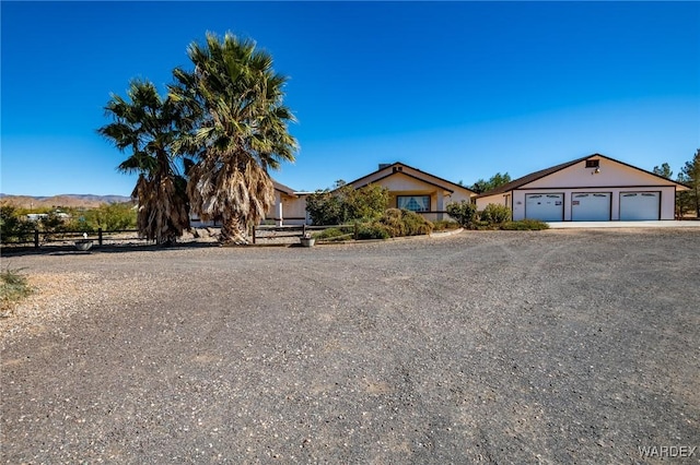 view of front facade featuring a garage, driveway, and a mountain view