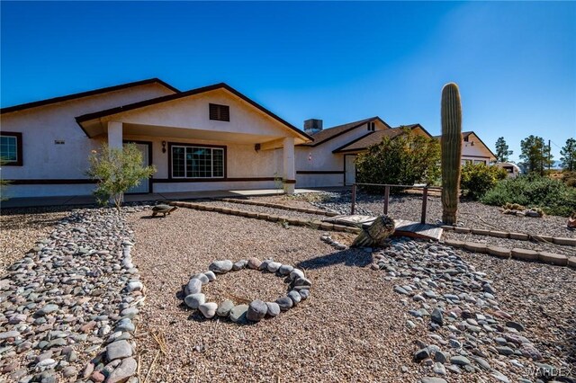 view of front of home with fence and stucco siding