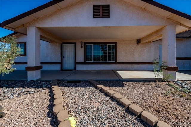 back of property featuring a patio area and stucco siding