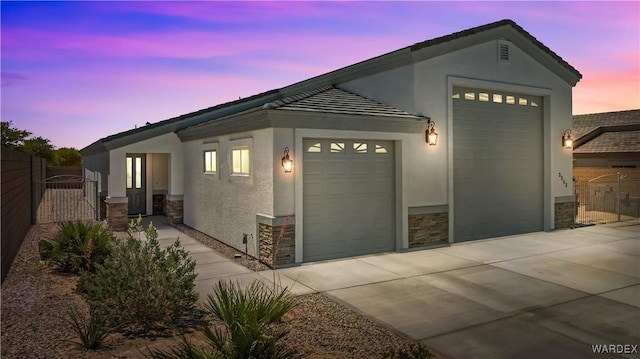 2542 E Alterna Dr, Fort Mohave, AZ 86426 - ranch-style home with stucco siding, an attached garage, fence, and stone siding